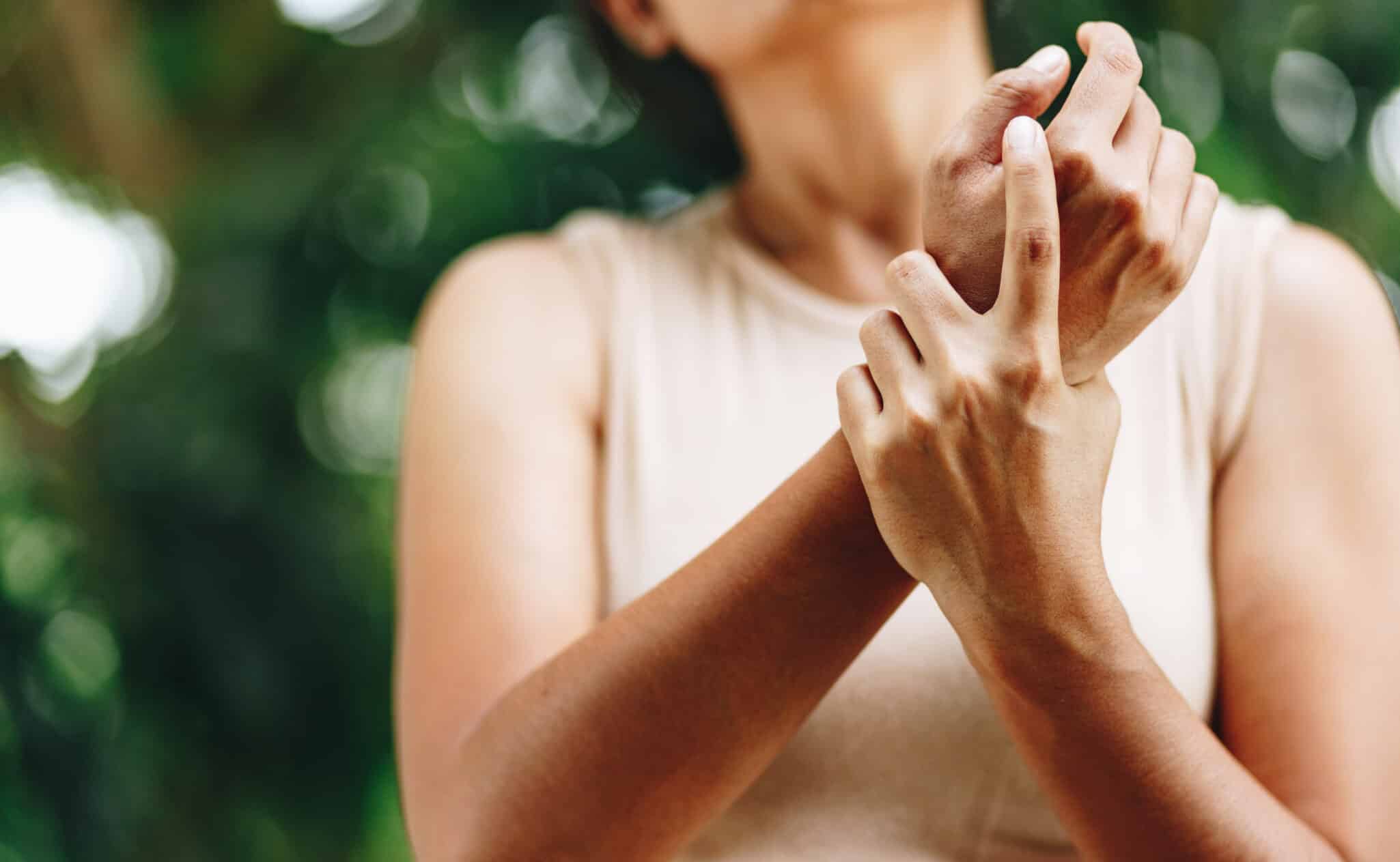 Woman holding her wrist in pain due to carpal tunnel syndrome symptoms, needing release procedure