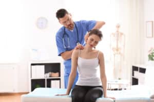 Woman having her neck pain examined by her doctor in need of a posterior cervical foraminotomy